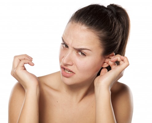 young woman has itching in the ear