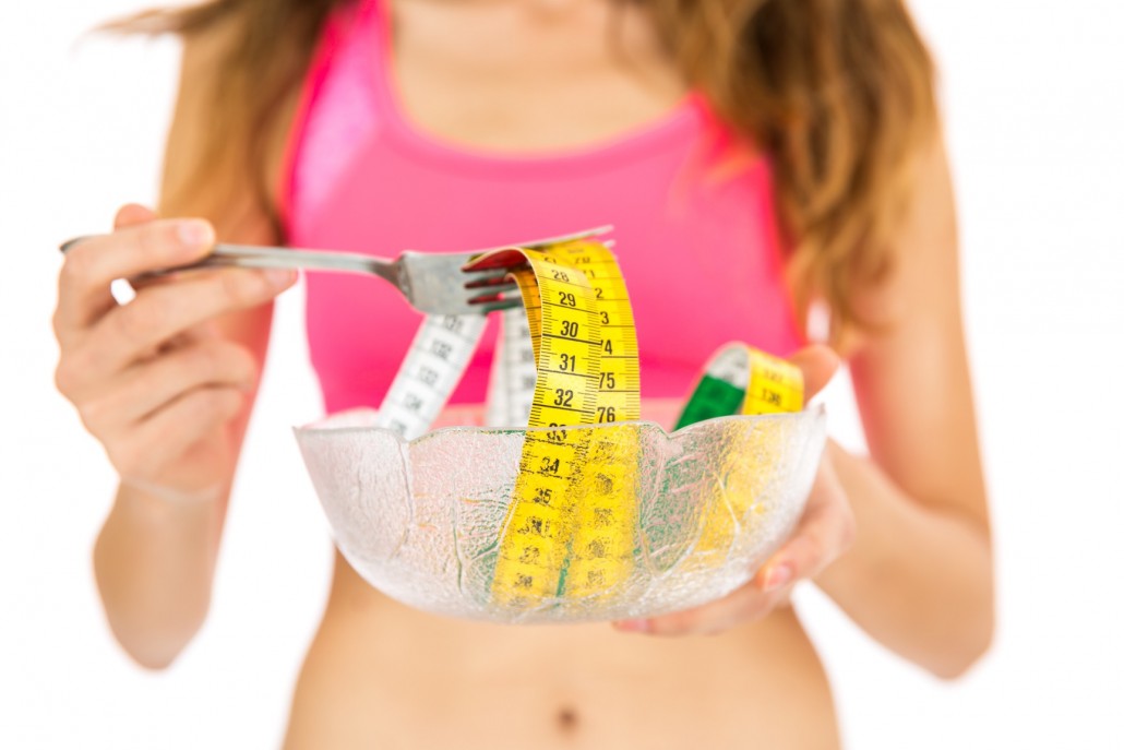 BM_Diet woman with measurement tape around her fork_94133504