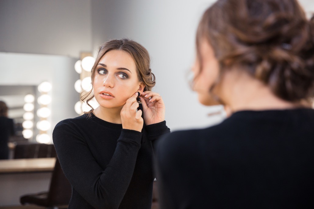BM_Woman putting on earring_98094367