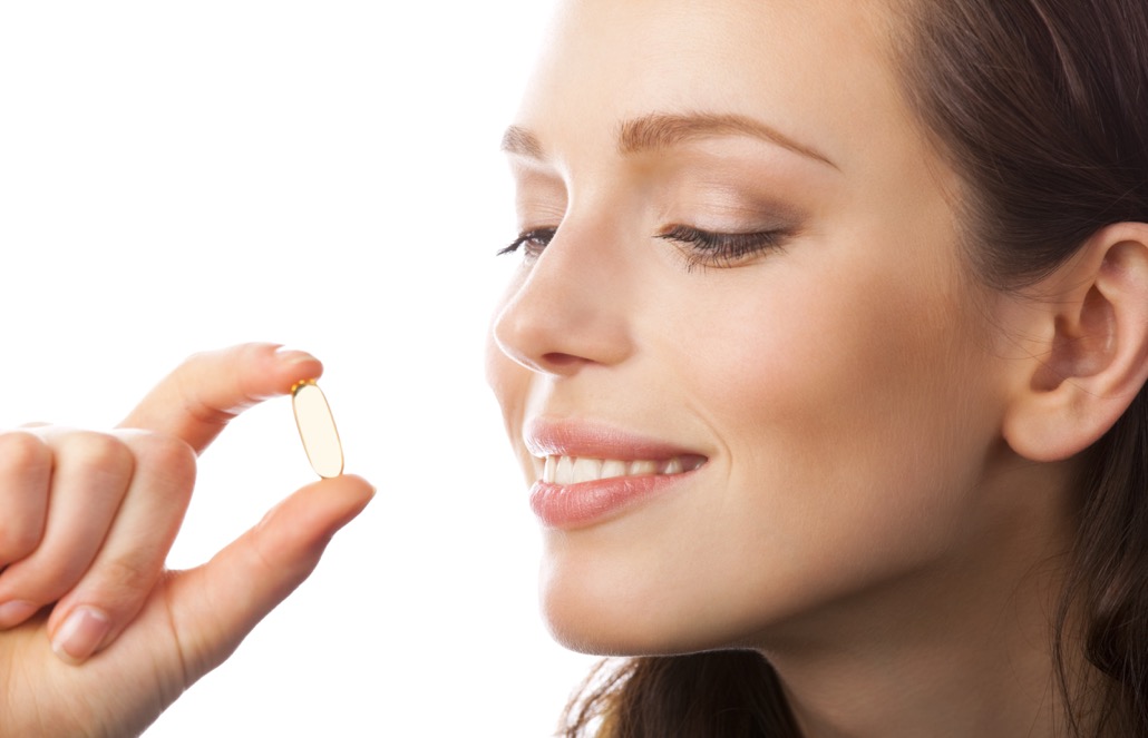 BM_Portrait of woman with Omega 3 fish oil capsule, isolated_27970464
