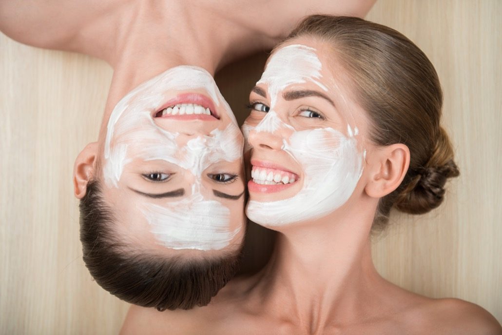 bm_two-beautiful-girls-applying-facial-cream-mask-and-beauty-treatm_69752233