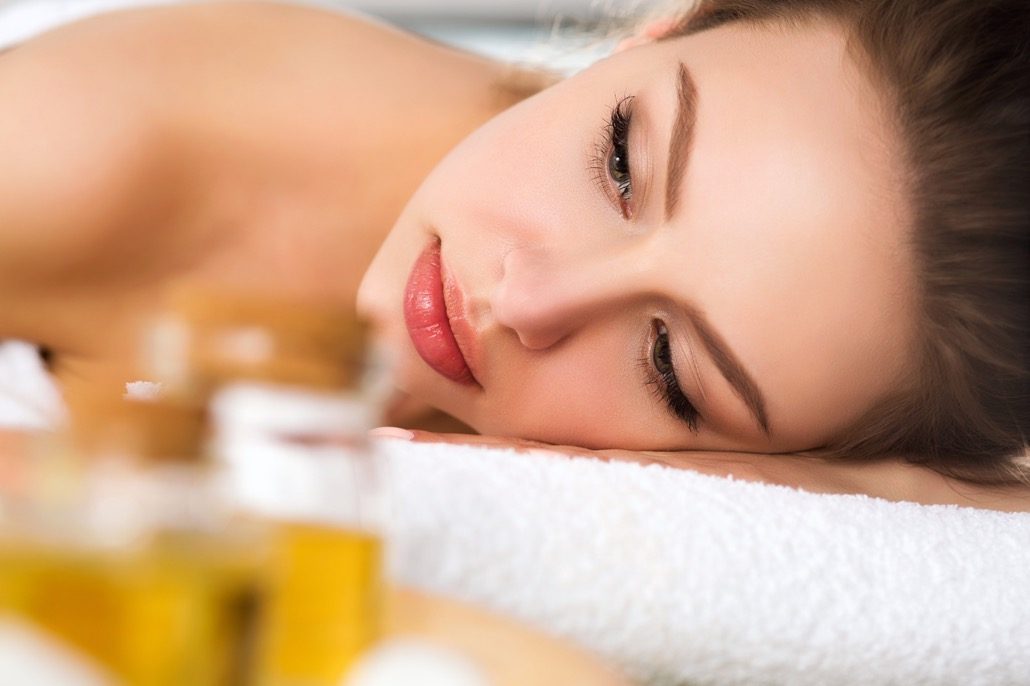 BM_Beautiful young woman laying at spa salon_121762594