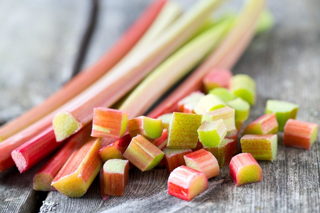 BM_freshly cut pieces of rhubarb on wooden surface_83497474